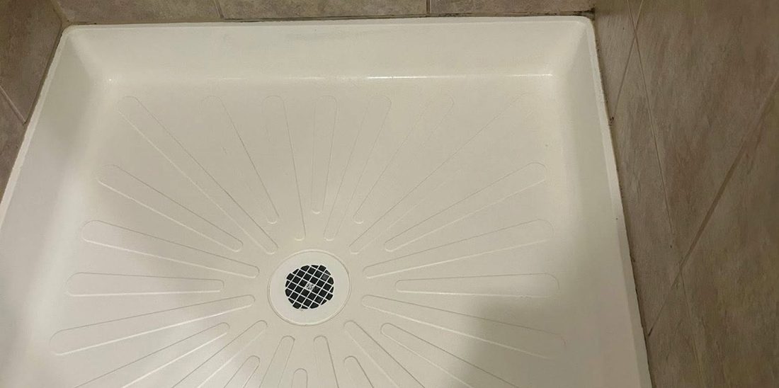 The same shower pan scrubbed clean and bright