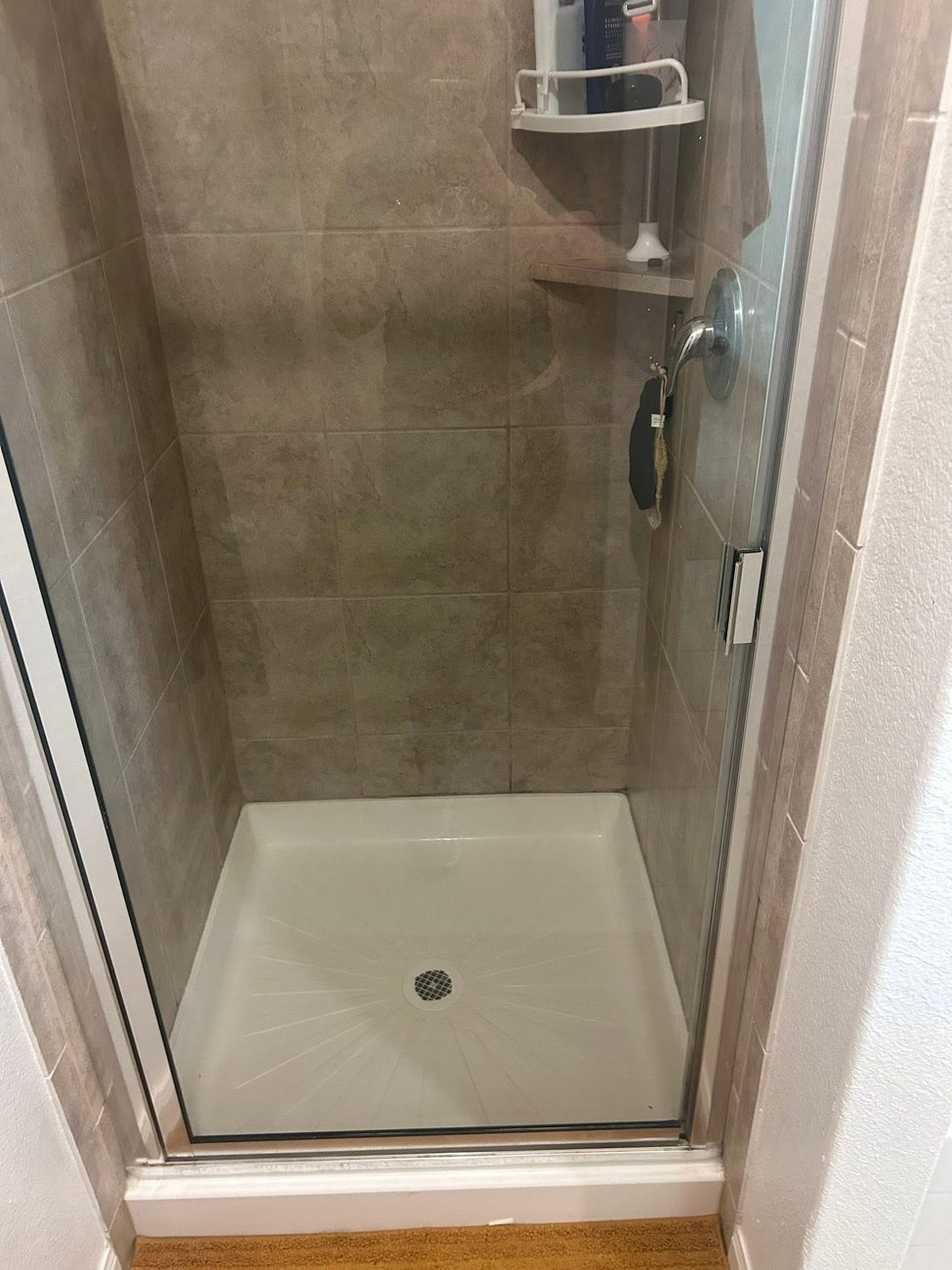 A tiled shower stall cleaned throughout